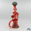 Red Glass Recycler Rig: Curse Glass, Full-Color Design, Enhanced Filtration, Striking Red Finish, Expert Craftsmanship, Superior Functionality, Smooth Filtered Hits, Compact and Durable, Perfectly Sized, Portability, Artisan Quality, High-End Glass Rig, Performance and Aesthetics.